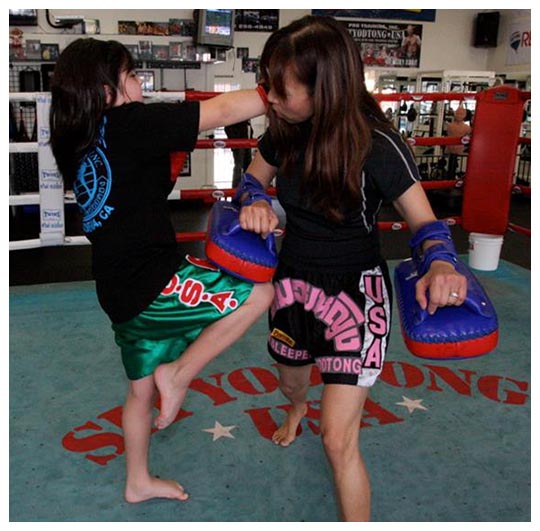 Kid Power Student kneeing with Instructor June Castro-Michalowski